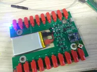 Battery-powered test fixture with many red banana jacks and a Bluetooth module Battery-powered test fixture with many red banana jacks and a Bluetooth module