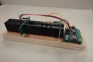 Longer spectrophotometer prototype mounted on a wooden base with external controller board Longer spectrophotometer prototype mounted on a wooden base with external controller board
