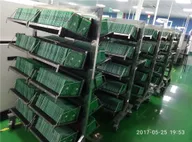Factory racks loaded with green PCBs drying or waiting after assembly Factory racks loaded with green PCBs drying or waiting after assembly